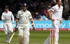 Sachin Tendulkar (C) walks off the pitch after losing his wicket to England's James Anderson (R) during day five, the last day, of the 1st test match on July 25, 2011. Picture: AFP