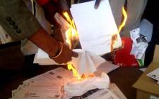 People burn their e-toll bills at an event to launch the next phase of Cosatu’s defiance campaign against the collection system, Braamfontein, Johannesburg, 24 July 2014. Picture: Govan Whittles/EWN.