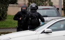 RAID police unit officers investigate at the house of the suspect of an attack at the Paris Orly’s airport, on 18 March, 2017 in Garges-les-Gonesse. Picture: AFP.