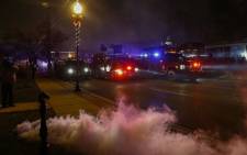 Tear gas spews out of canisters fired by police as they move forward in vehicles to confront protesters in Ferguson, Missouri, Missouri, USA, 24 November 2014. Picture: EPA.