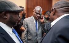 FILE: Democratic Republic of Congo joint opposition presidential candidate Martin Fayulu (C) speaks on his mobile phone following his designation on 11 November, 2018 in Geneva. Picture: AFP