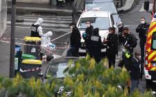 French police and forensic officers inspect the scene of an attack after several people were injured near the former offices of the French satirical magazine 'Charlie Hebdo' by a man wielding a knife in the capital Paris on 25 September 2020. Picture: AFP. 
