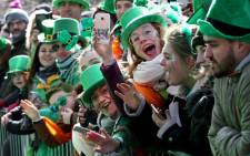 FILE: Spectators line the route during the annual St Patrick's Day parade through the city centre of Dublin on 17 March 2019. Picture: AFP