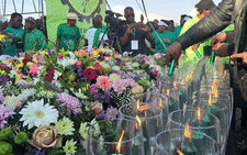 Candles are lit to commemorate the miners who died today three years ago. Flowers are handed to their family. Picture: Emily Corke/EWN.