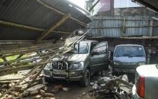 A man checks cars in a garage damaged by cyclone Amphan in Satkhira on 21 May 2020.  Picture: AFP
