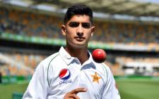 Pakistan's 16-year-old paceman Naseem Shah tosses the ball during a training session at Gabba in Brisbane on 20 November 2019, ahead of the first cricket Test match against Australia. Picture: AFP