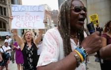 A small and peacful group of demonstrators gather to protest in front of the Baltimore City Circuit Courthouse East where pre-trial hearings will be held for six police officers charged in the death of Freddie Gray on 2 September, 2015 in Baltimore. Picture: AFP.