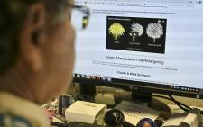 An AFP journalist views an example of a 'deepfake' video manipulated using artificial intelligence, by Carnegie Mellon University researchers, from his desk in Washington, DC 25 January 2019. Picture: AFP
