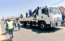 JMPD officers and City Power officials conducted an illegal electricity connection operation in Alexandra on 21 September 2021. All exit streets were then closed off by protesting residents with burning tyres and big stones. Picture: JMPD.