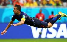 'Flying Dutchman' Robin van Persie of the Netherlands scores the equalising goal with a diving header in the first half during the 2014 FIFA World Cup Brazil Group B match between Spain and Netherlands at Arena Fonte Nova, Salvador, Brazil, 13 June 2014. Picture: Fifa.