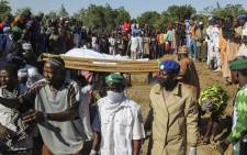 FILE: Mourners attend the funeral of 43 farm workers in Zabarmari, about 20km from Maiduguri, Nigeria, on 29 November 2020 after they were killed by Boko Haram fighters in rice fields near the village of Koshobe on 28 November 2020. Picture: AFP
