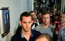 American swimmers Gunnar Bentz (L) and Jack Conger leave the police station at the Rio de Janeiro International Airport after being detained on the plane that would travel back to the US. Picture: AFP.