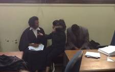 A woman confers with her lawyer in the Johannesburg Magistrate's Court on 22 January 2013, when she appeared for allegedly murdering US Consulate employee Christopher Bates. Picture: Andrea van Wyk/EWN
