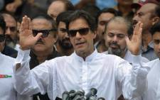 Pakistan's cricketer-turned politician Imran Khan of the Pakistan Tehreek-e-Insaf (Movement for Justice) speaks to the media after casting his vote at a polling station during the general election in Islamabad on 25 July 2018. Picture: AFP