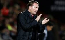 Liverpool's Northern Irish manager Brendan Rodgers applauds on the touchline during the English League Cup quarter-final football match between Bournemouth and Liverpool on 17 December, 2014. Picture: AFP.