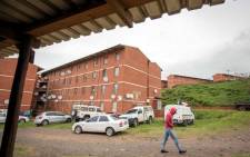A resident passes the Russia, or R Block, of the Glebelands hostel, allegedly a haven for hitmen who operate throughout the province of KwaZulu-Natal in 2017 in Durban. Picture: AFP.