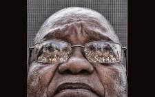 FILE: The crowd who gathered to support former President Jacob Zuma is seen reflected in his glasses as he waits to speak after appearing on corruption charges at the Durban High Court on 6 April 2018. Picture: EWN.