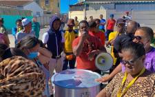 Lavender Hill residents wait for a hot meal provided by NGO Philisa Abafazi Bethu. Picture: Kaylynn Palm/EWN