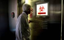 Pat Leman of the special pathology unit at the National Institute for Communicable Diseases enters a biohazard laboratory at the facility in Johannesburg, on 30 October 2008. Picture: Werner Beukes/SAPA