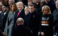 (From L) Moroccan King Mohammed VI, US First Lady Melania Trump, US President Donald Trump, German Chancellor Angela Merkel, French President Emmanuel Macron and French President's wife Brigitte Macron react as Russian President Vladimir Putin (front C) arrives to attend a ceremony at the Arc de Triomphe in Paris on November 11, 2018 as part of commemorations marking the 100th anniversary of the 11 November 1918 armistice, ending World War I.  Picture: AFP.