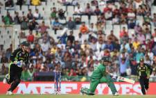 Pakistan's Umar Akmal is bowled out as Australia's wicketkeeper Peter Nevill (L) looks on during the World T20 cricket tournament match between Australia and Pakistan at The Punjab Cricket Stadium Association Stadium in Mohali on 25 March 2016. Picture: AFP.