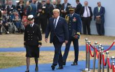 US President Donald Trump (C) returns to his seat after speaking during an event to commemorate the 75th anniversary of the D-Day landings, in Portsmouth, southern England, on 5 June 2019. Picture: AFP