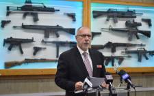 FILE: Detective Chief Inspector Wayne Hoffman of the New South Wales Police speaks to the media at a press conference at their headquarters in Sydney on 8 August, 2017, as guns previously seized from criminals are seen behind him. Picture: AFP.