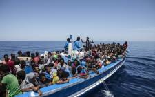 This handout picture taken on 3 May 2015 released by the Migrant Offshore Aid Station (MOAS) shows migrants aboard a wooden boat on the Mediterranean sea. Picture: AFP/MOAS.