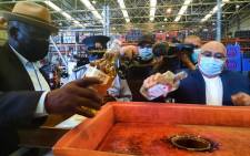 Police Minister Bheki Cele,  Western Cape MEC for Safety Albert Fritz and SAPS officers destroy bottles of alcohol at the police's central liquor storage facility in Belhar, Cape Town on 20 December 2021. Picture: Kaylynn Palm/Eyewitness News