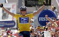 Lance Armstrong celebrating as he crosses the finish line and wins the Tour de France cycling race. Picture: AFP