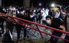 FILE: Protesters block the protest area of Legislative Council with barricades during clashes with police after a rally against a controversial extradition law proposal in Hong Kong on 10 June  2019. 