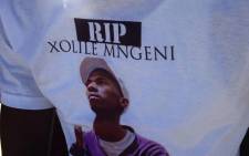 Some family members are wearing t-shirts with a picture of him reading Rest In Peace, Xolile Mngeni. Picture: Lauren Isaacs/EWN.