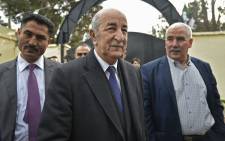 Algerian presidential candidate Abdelmadjid Tebboune (C) arrives to cast his ballot in the capital Algiers on 12 December 2019. Picture: AFP
