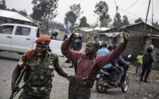 A man is arrested by a member of the military police after people attempted to block the road with rocks, in the neighbourhood of Majengo in Goma, eastern Democratic Republic of the Congo, on 19 December 2016, as tensions rose with one day left of Congolese President Joseph Kabila's mandate. Picture: AFP.