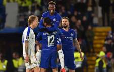 Chelsea's English midfielder Callum Hudson-Odoi (C) leaps into the arms of Chelsea's English midfielder Ruben Loftus-Cheek after scoring their third goal during the first leg of the UEFA Europa League round of 16 football match between Chelsea and Dynamo Kiev at Stamford Bridge stadium in London on 7 March 2019. Picture: AFP