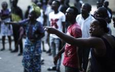 Angry voters at the SG Angola Libre school in the Makelele district of Brazzaville react while the ballots were counted in the polling station at the end of the vote for the presidential election on 20 March, 2016. Picture: AFP.