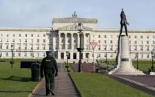 A policeman patrols the Parliament Buildings on the Stormont Estate, the seat of the Northern Ireland assembly, in Belfast on 12 February 2018. Picture: AFP