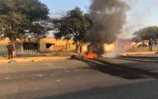 Debris burns in a Soweto road during service delivery protests on 2 May 2018. Picture: Mia Lindeque/EWN
