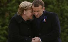 French President Emmanuel Macron and German Chancellor Angela Merkel hug after unveiling a plaque in a French-German ceremony in the clearing of Rethondes (the Glade of the Armistice) in Compiegne, northern France, on 10 November 2018 as part of commemorations marking the 100th anniversary of the 11 November 1918 armistice, ending World War I. Picture: AFP