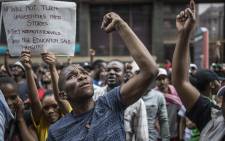 Students shout slogans outside the African National Congress ruling party (ANC) headquarters, on October 22 2015, in Johannesburg during a demonstration against university fee hikes. Picture: AFP.
