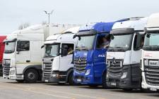 Drivers sit in their cabs as they wait at a truck stop off the M20 leading to Dover near Folkestone in Kent, southeast England on 22 December 2020, after France closed its borders to accompanied freight arriving from the UK due to the rapid spread of a new coronavirus strain. Picture: AFP