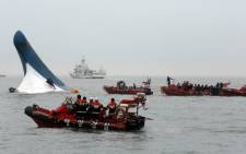South Korea Coast Guard members searching for passengers near a South Korean ferry after it capsized on its way to Jeju island from Incheon on 16 April 2014. Picture: AFP.