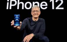 FILE: Apple CEO Tim Cook holds up the iPhone 12 Pro during an Apple event at Apple Park in Cupertino, California on 13 October 2020. Picture: Brooks Kraft/AFP