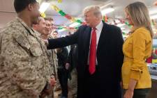 US President Donald Trump and First Lady Melania Trump greet members of the US military during an unannounced trip to Al Asad Air Base in Iraq on 26 December 2018. President Donald Trump arrived in Iraq on his first visit to US troops deployed in a war zone since his election two years ago. Picture: AFP
