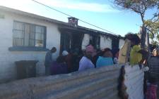 Residents stand at the site where a house fire killed six people in Bonteheuwel on 26 October 2016. Picture: Lauren Isaacs/EWN.