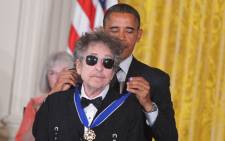 US President Barack Obama presents the Presidential Medal of Freedom to musician Bob Dylan during a ceremony on May 29, 2012 in the East Room of the White House in Washington. Picture: AFP