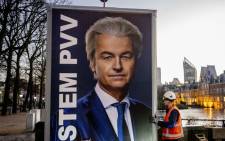Workers prepare to remove an election sign of Party for Freedom (PVV) leader Geert Wilders near the Binnenhof, a day after the Netherlands general elections, in the Hague on 23 November 2023. Picture: AFP