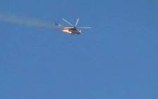 An image grab that was taken from a video uploaded on YouTube on August 27, 2012 showing a burning Syrian combat helicopter crashing. Picture: AFP.
