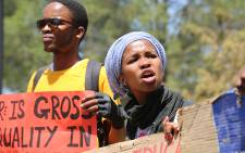 A female student pleads with her peers not to throw rocks at police during a protest at the Union Buildings in Pretoria on 23 October 2015. Picture: Reinart Toerien/EWN.