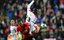 Manchester United's Belgian defender Marnick Vermijl vies with MK Dons English striker Benik Afobe (R) during the English League Cup second round football match between Milton Keynes Dons and Manchester United at Stadium MK in Milton Keynes, north of London, on 26 August, 2014. Picture: AFP.